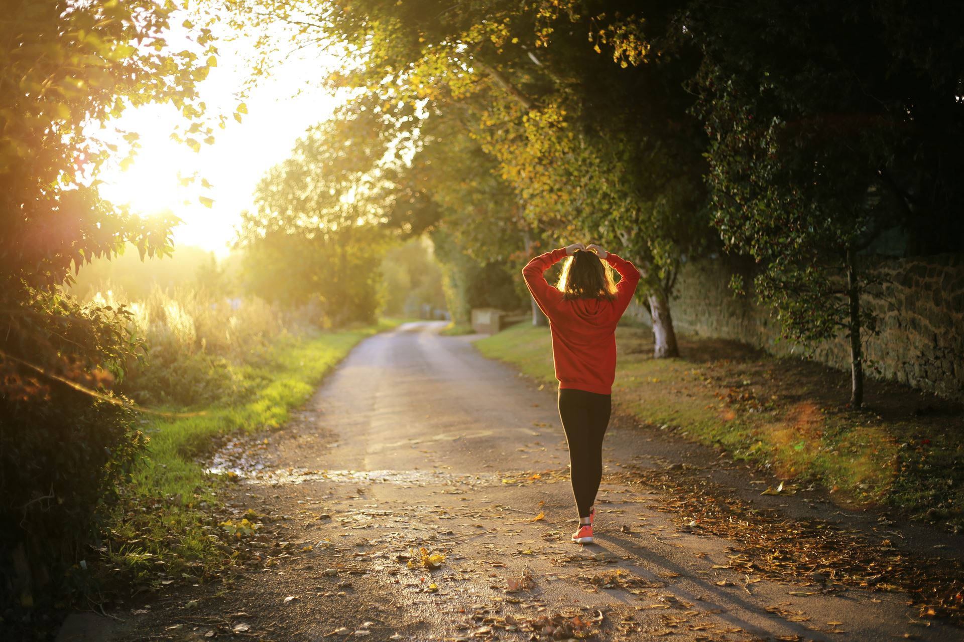 A woman on a jog down a path in a park